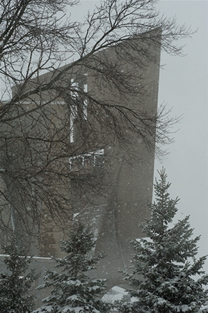 Photo of the Saint John's Abbey in the winter time speckled with snow
