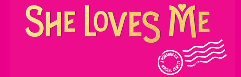 Bold yellow text reads "She Loves Me" against a pink background. A small design resembling a postage stamp in white includes the words "A Romantic Musical Comedy." Curved lines mimic a postal mark.