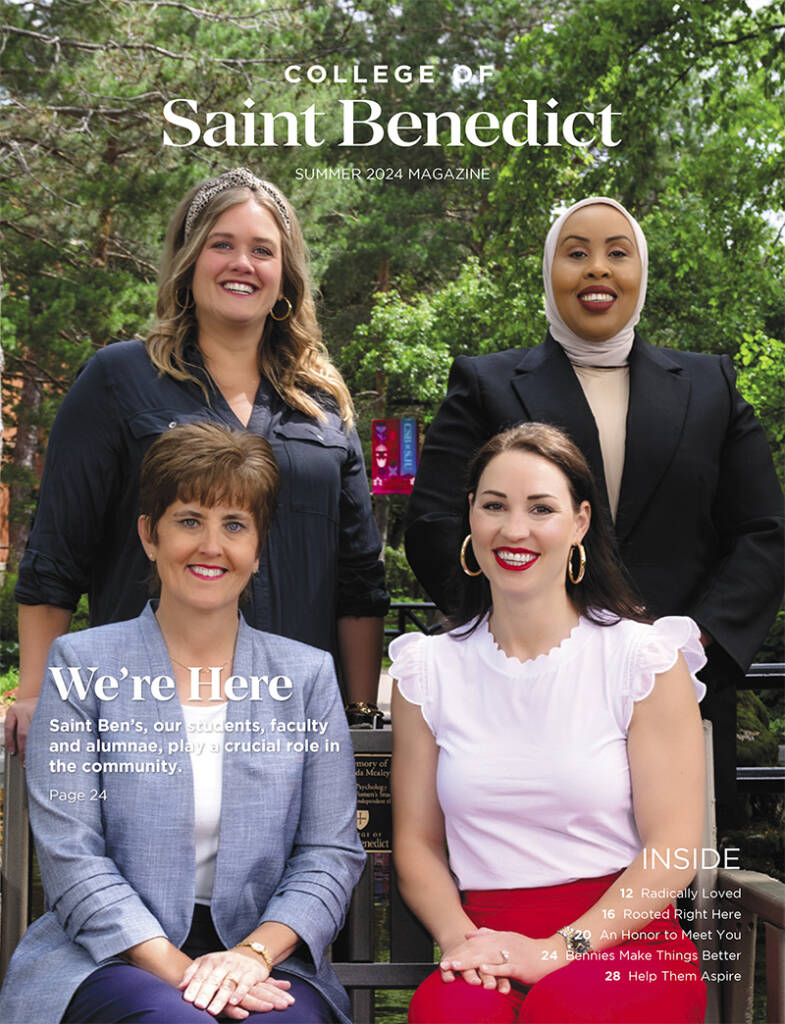 Four women smile while seated and standing outdoors in front of trees. The magazine cover reads "College of Saint Benedict, Summer 2024 Magazine" and features content headlines like "Radically Loved" and "Help Them Aspire.