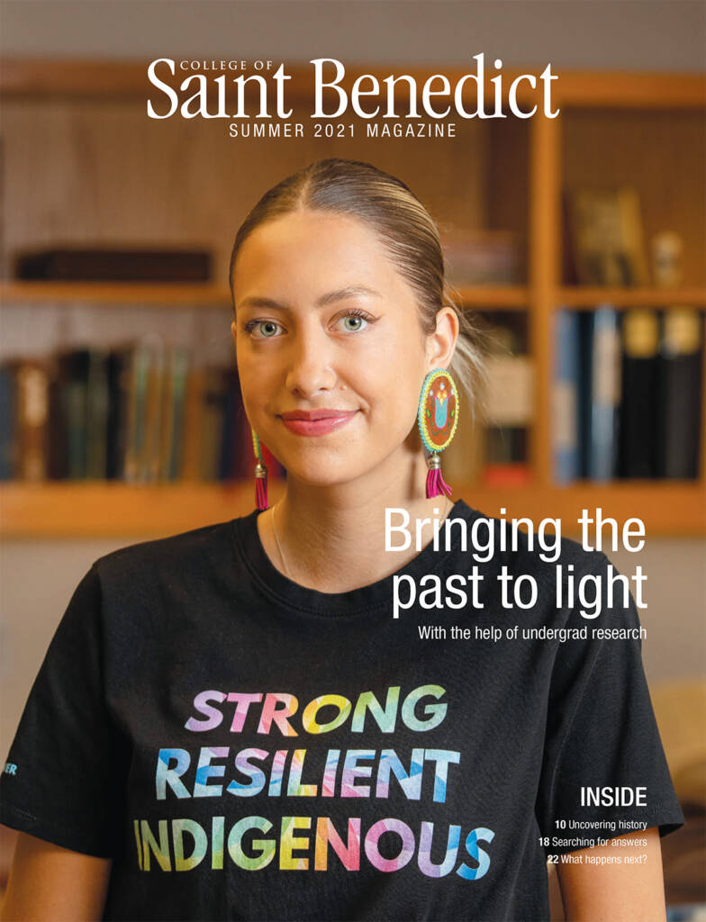 A woman with braided hair, wearing colorful earrings and a "Strong Resilient Indigenous" T-shirt, smiles at the camera. She is featured on the cover of the College of Saint Benedict Summer 2021 Magazine. Text reads "Bringing the past to light.