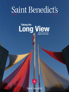 A magazine cover titled "Saint Benedict's" with the headline "Taking the Long View." It features a sky view with red and white fabric sails and a flagpole. The issue is from Fall 2023, and includes the College of Saint Benedict logo at the bottom.