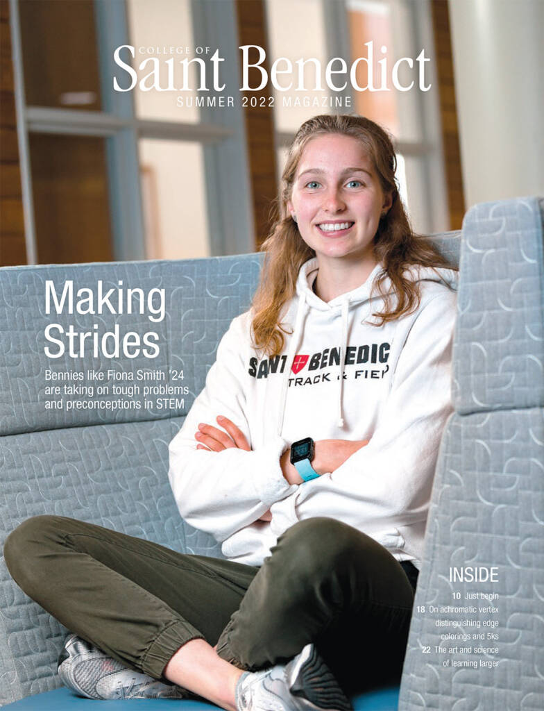 Young woman smiling, seated on a patterned couch, wearing a "Saint Benedict Track & Field" hoodie and black pants. She has long hair and wears a smartwatch. Text on the image includes "Making Strides" and "College of Saint Benedict Summer 2022 Magazine.