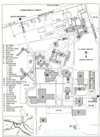 A detailed campus map showing buildings, roads, and parking lots. Key structures are labeled with letters and numbers. Main landmarks include academic buildings, residence halls, and common areas. North entrance and other key points are marked for navigation.