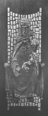 Relief sculpture of a crowned woman holding a crowned child, both seated, with a mosaic-like background of square tiles. The figures appear regal, likely depicting a Madonna and Child.