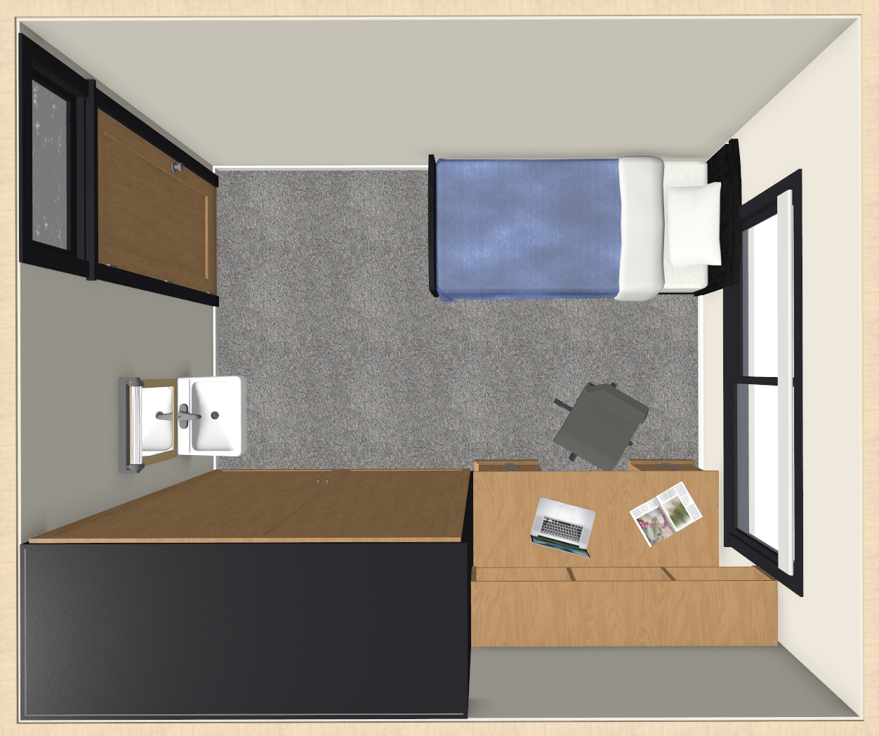 Top view of a small room with a bed on the left with a blue blanket, a desk with a laptop and papers near the top window, a chair, a wardrobe, a sink and mirror on the right wall, and a door near the bottom. The floor is carpeted.