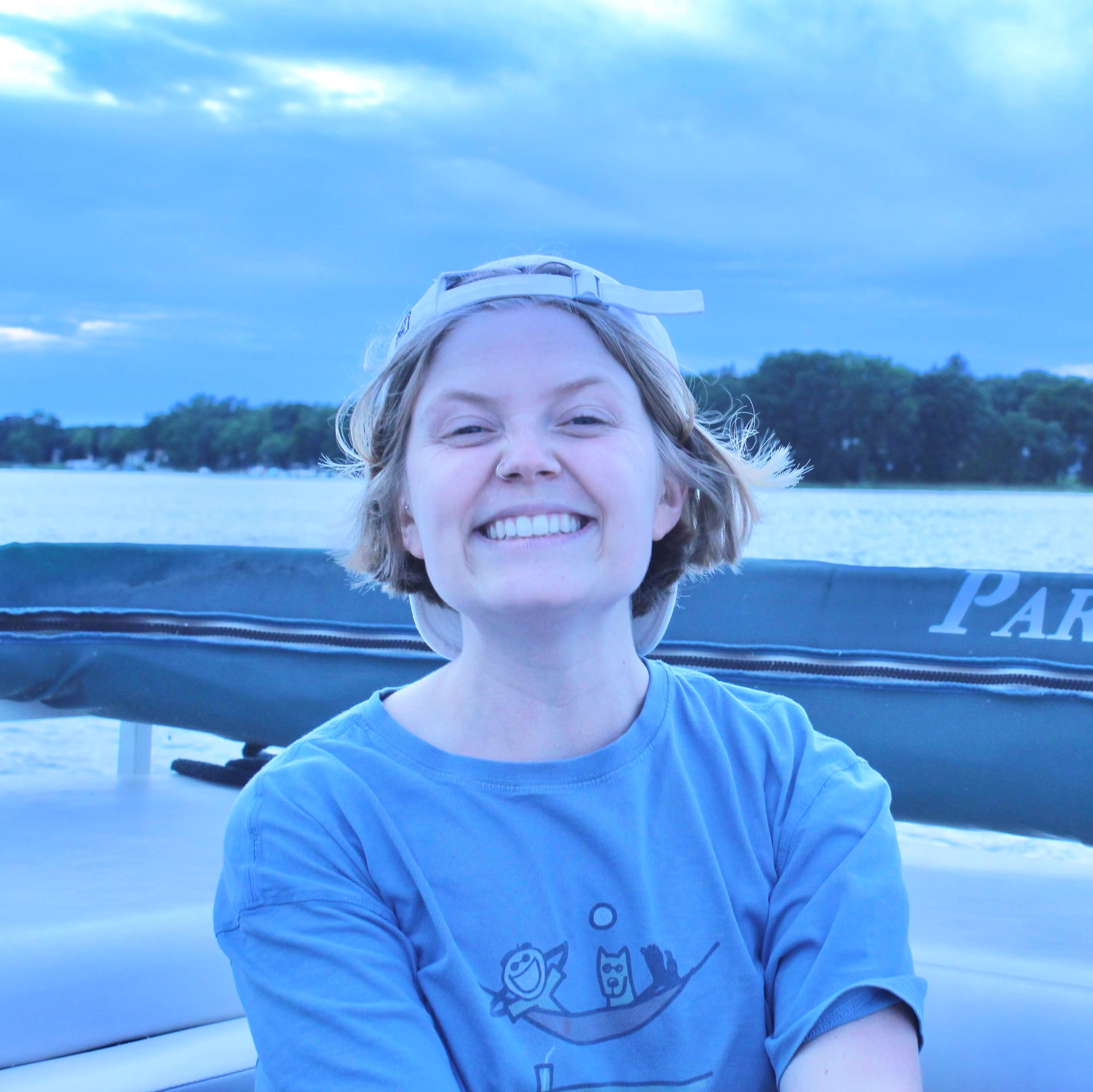 Smiling girl on a boat in a blue shirt 