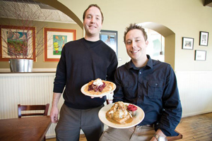 Photo of Adam and Andrew Sieve serving breakfast at their restaurant