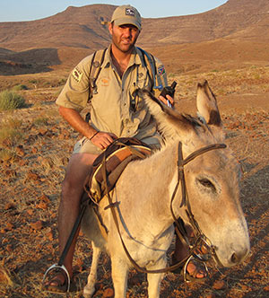Photo of Jeff Muntifering '99 riding a donkey