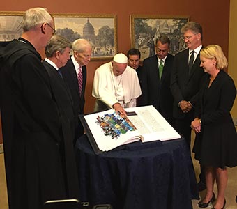 Photo of Pope Francis looking at the Saint John's Bible