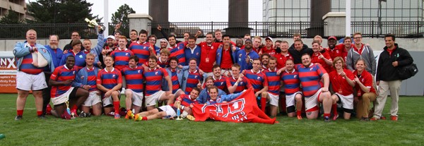 Photo of the rugby team holding an SJU flag in Colorado