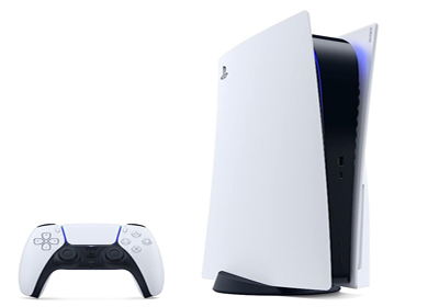 A white and black PlayStation 5 console is displayed vertically on a stand. To the left of the console is a matching PlayStation 5 DualSense wireless controller, also white with black accents. The console emits a subtle blue light from within.