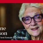 A smiling elderly woman with short white hair and glasses sits in front of a blurred background. Text reads: “Marlene Johnson, Minnesota’s First Female Lt. Governor.” A white geometric logo appears in the top right corner.