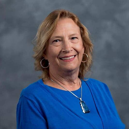 A woman in a blue shirt.