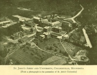 A vintage aerial photograph of St. John's Abbey and University in Collegeville, Minnesota. The campus includes several large buildings surrounded by trees and pathways. Captioned as part of St. John's University's archives.