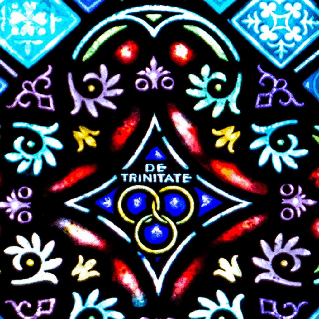 A colorful stained glass window features floral patterns, geometric shapes, and a central design with three interlocking yellow rings surrounding the Latin words "DE TRINITATE" on a deep blue background.