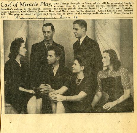 A vintage newspaper clipping featuring six people from the cast of a play titled "The Tidings Brought to Mary." They are seated and standing in two rows, dressed formally. Handwritten notes are visible, and the text describes the event details.
