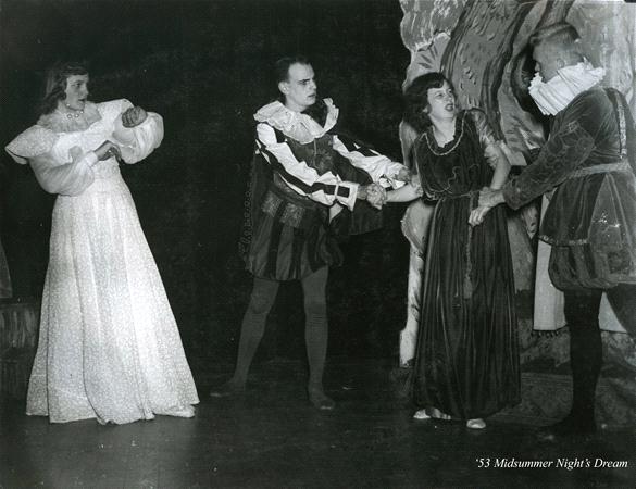 Four actors in period costumes are performing a scene on stage. Two are interacting closely, while the others watch, one looking amused and the other contemplative. The caption reads "'53 Midsummer Night's Dream.