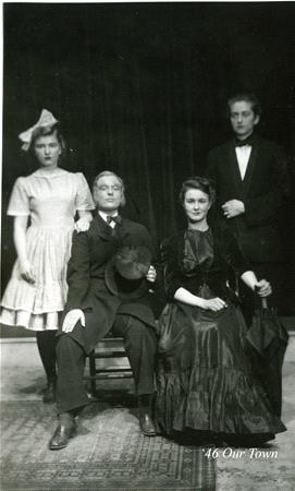 Four people in vintage attire pose for a formal portrait. Two men stand behind a seated man and woman. The woman on the left wears a dress with a bow, and the seated woman wears a long gown. The setting has a theatrical backdrop. Text reads "46 Our Town.