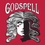 Stylized artwork of a face with intricate black and white swirls for hair, a red dot on the cheek, and split into light and dark halves. The word "Godspell" is in bold, white letters above, set against a red background.