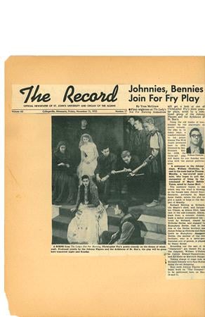 A newspaper page titled "The Record" features an article about a theater play. A large black-and-white photo shows actors in costume, portraying a dramatic scene. Various individuals are engaged in reading the script and performing.