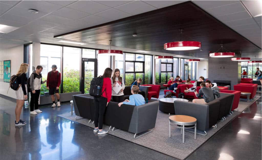 Many students conversing in the HAB lounge. 