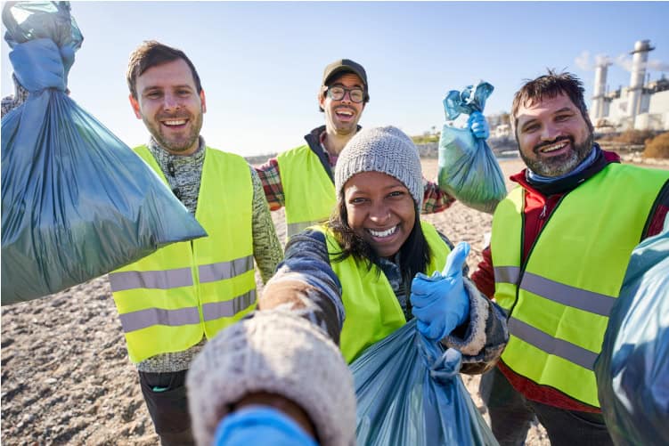 Students in hi-vis vests pose for a photo after a long day of community service.